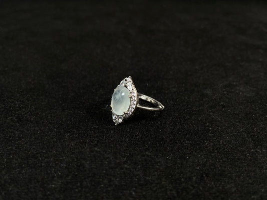 A round icy jade set in 925 silver with prong setting.