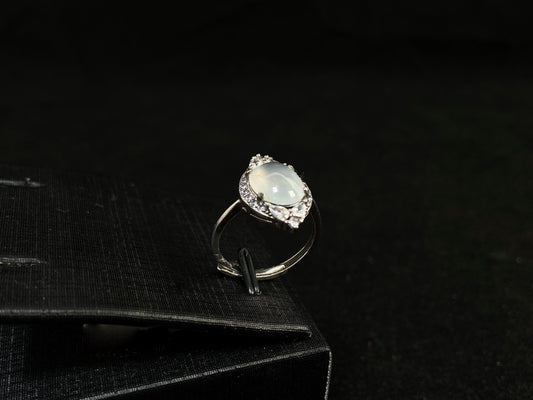 A round icy jade set in 925 silver with prong setting.