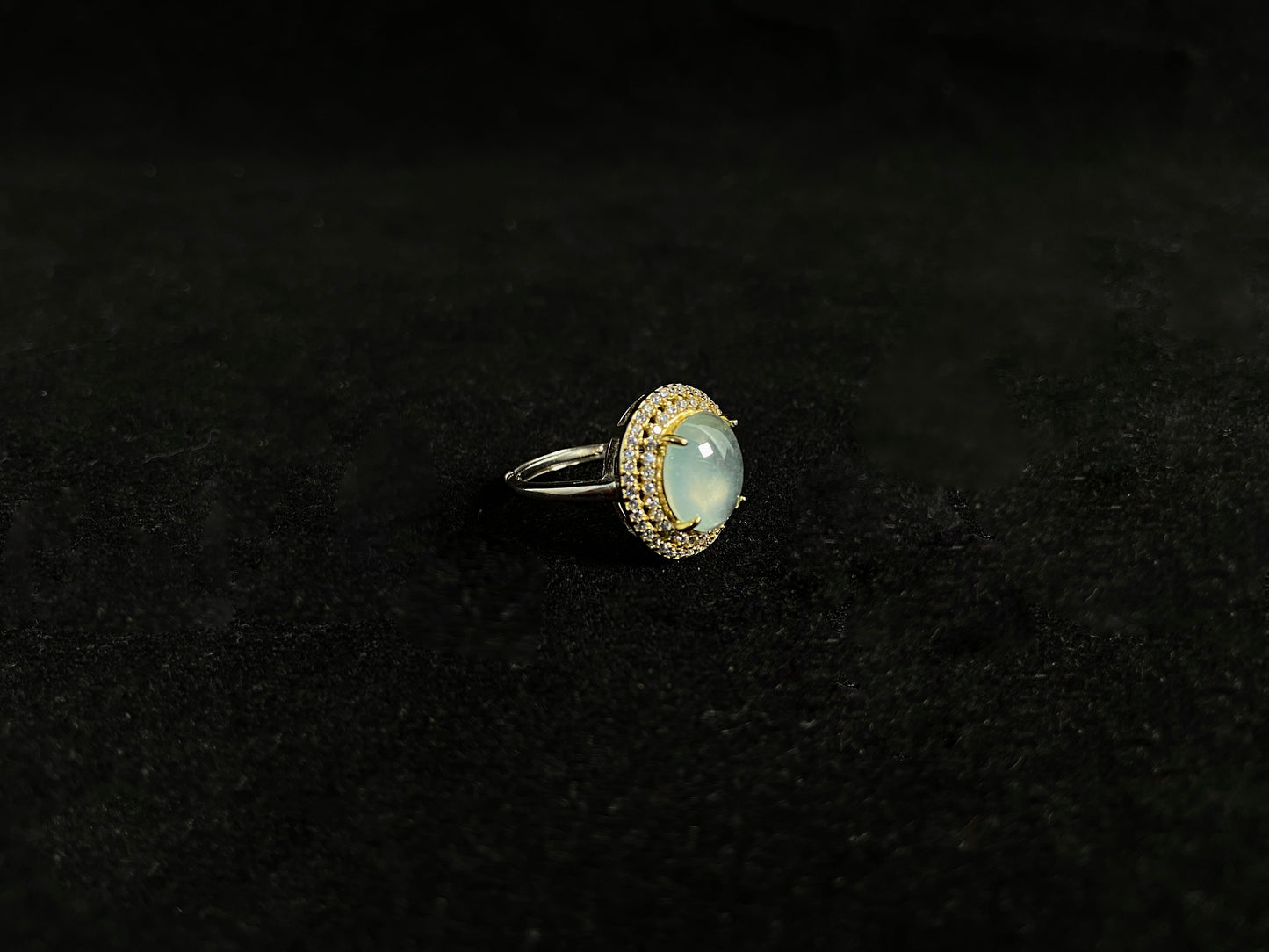 This exquisite ring features a perfectly round, transparent jadeite with exceptional clarity, elegantly secured by channel setting.