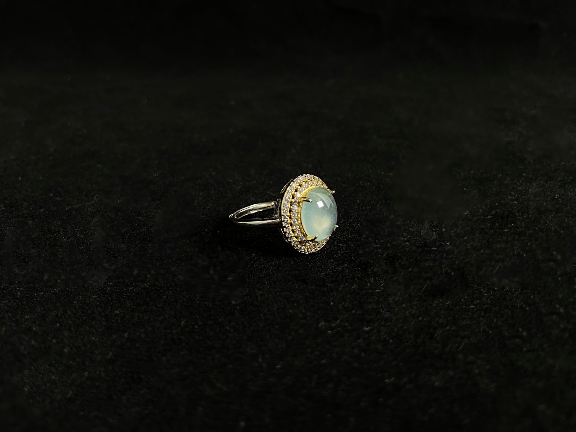 This exquisite ring features a perfectly round, transparent jadeite with exceptional clarity, elegantly secured by channel setting.