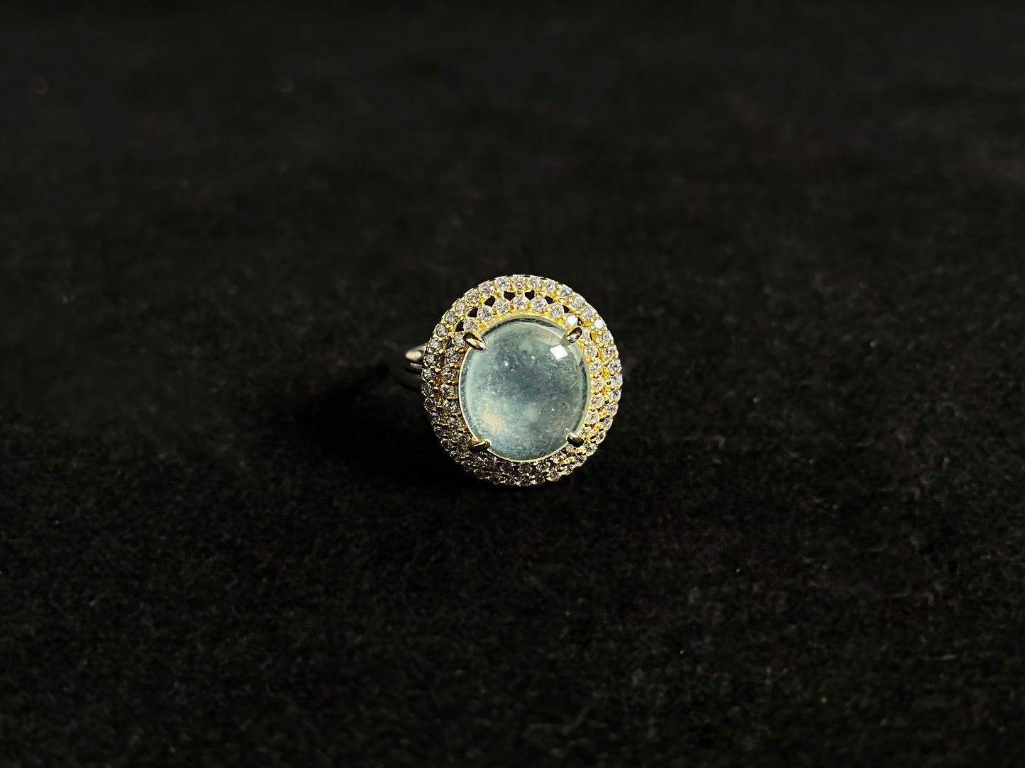 This exquisite ring features a perfectly round, transparent jadeite with exceptional clarity, elegantly secured by channel setting.