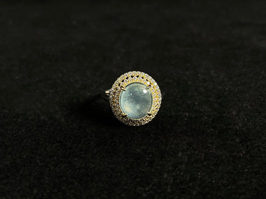 This exquisite ring features a perfectly round, transparent jadeite with exceptional clarity, elegantly secured by channel setting.