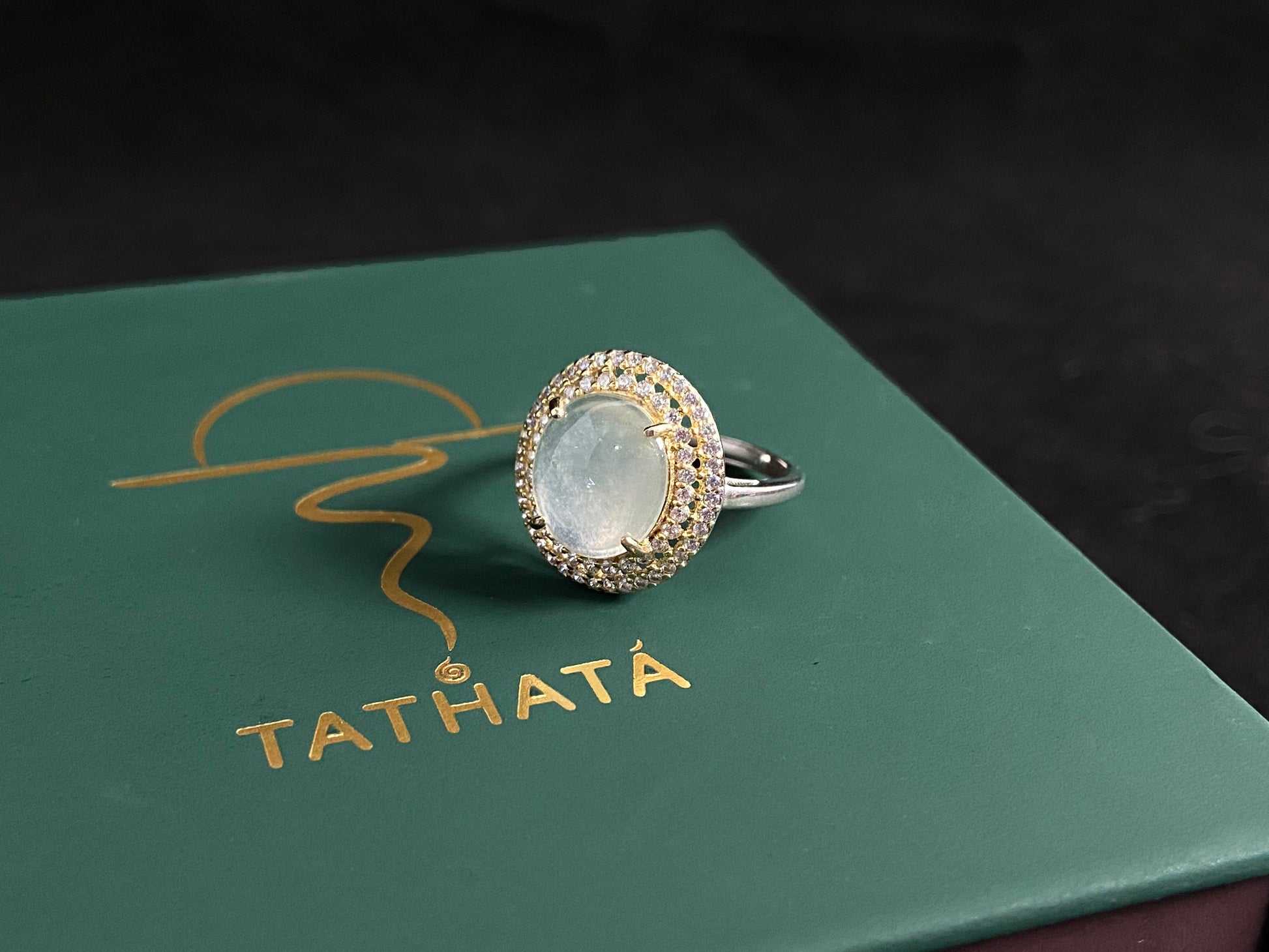 This exquisite ring features a perfectly round, transparent jadeite with exceptional clarity, elegantly secured by channel setting.