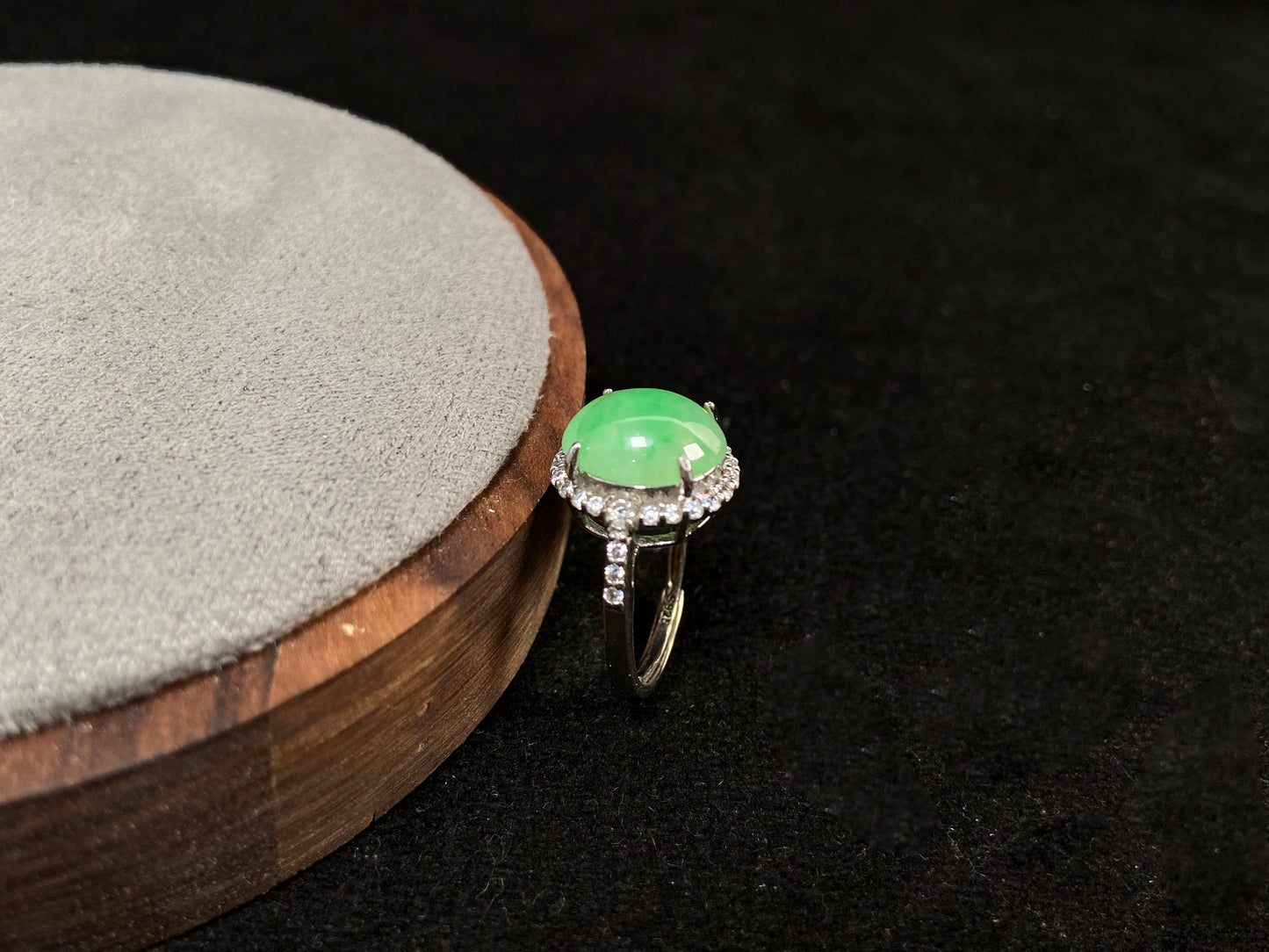 A round apple green jade set in 925 silver with prong setting.