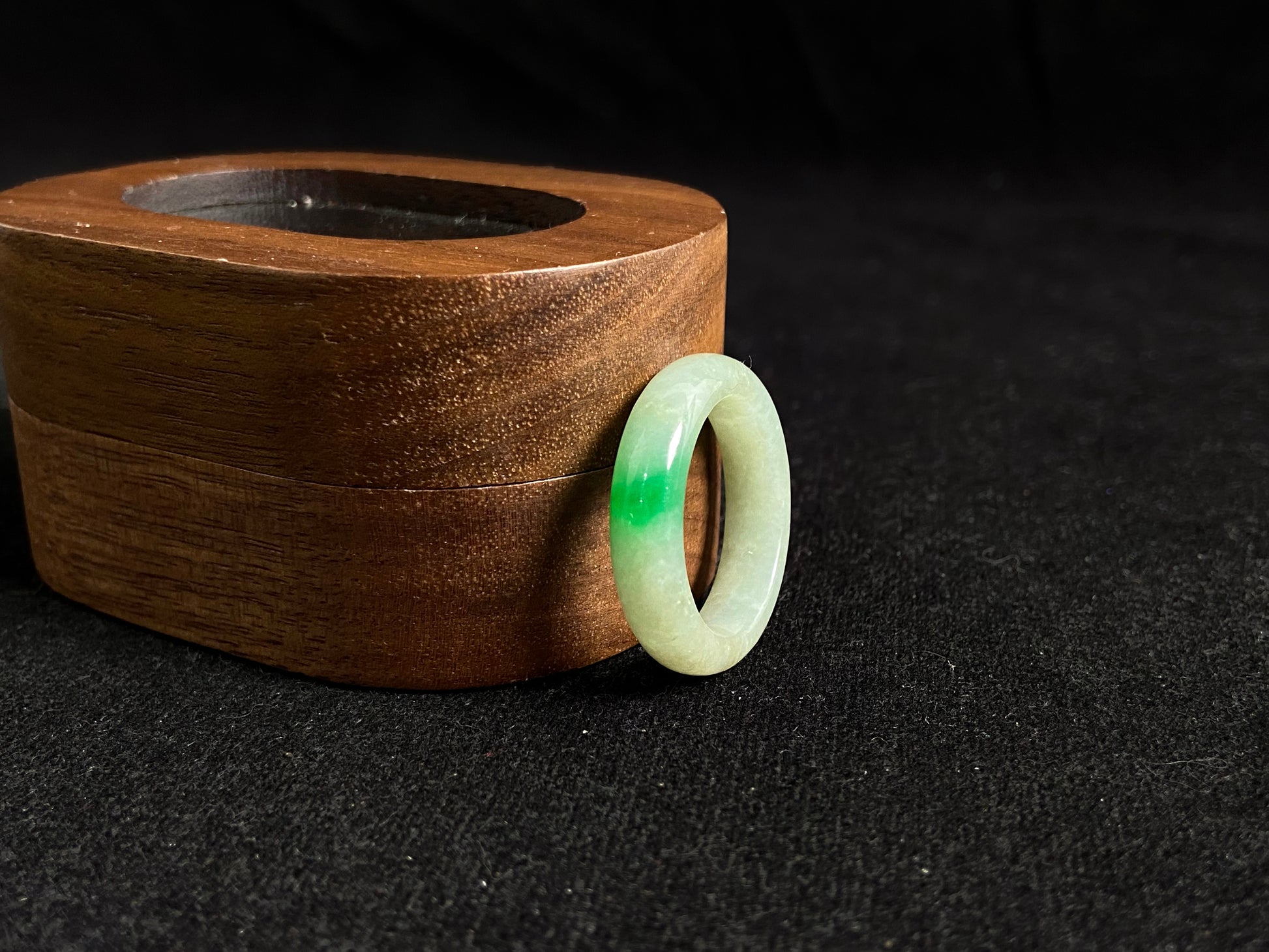 A milky white jadeite ring adorned with floating green accents.