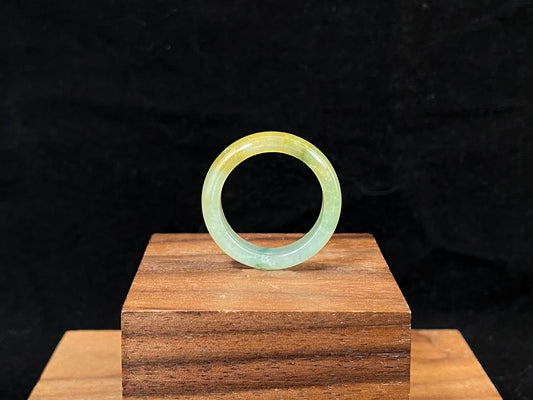 Icy white and gold jade harmoniously blended with green inclusions.