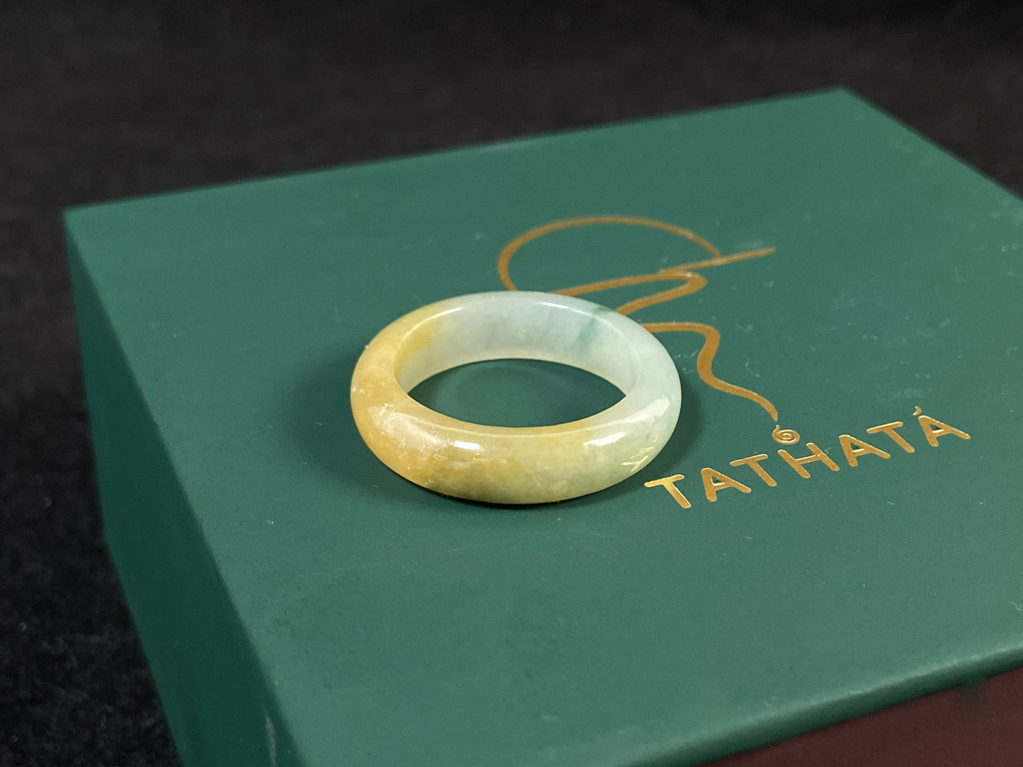 Icy white and gold jade harmoniously blended with green inclusions.