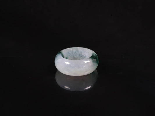 A white with dual deep green lines jadeite ring.