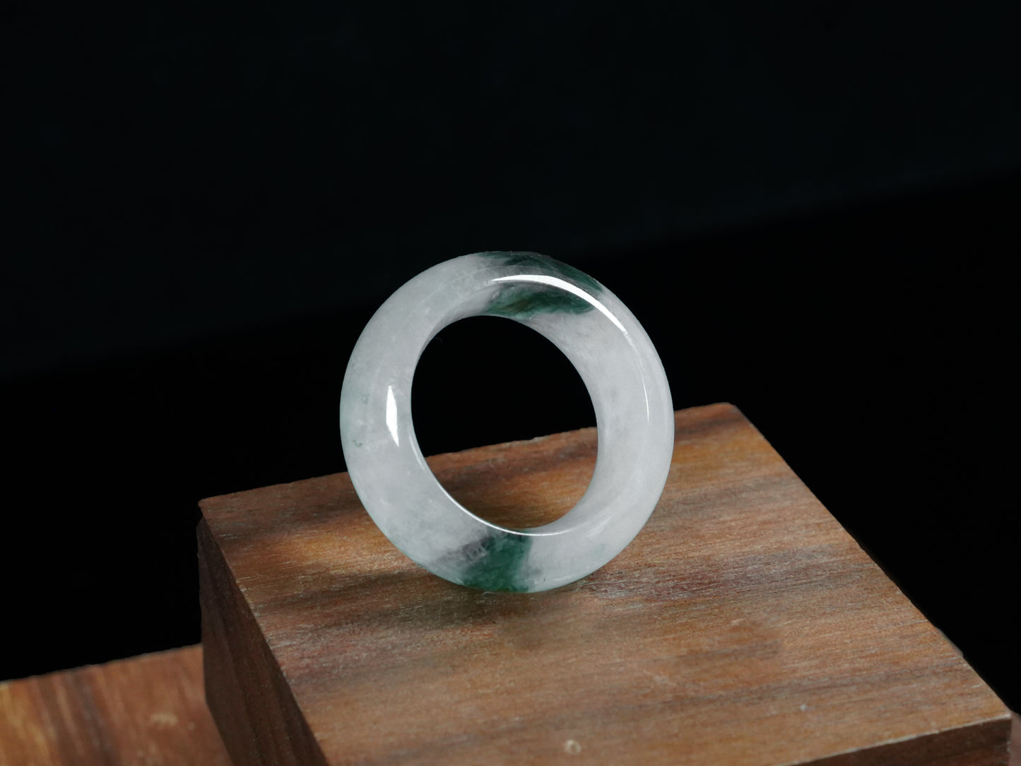 A white with dual deep green lines jadeite ring.