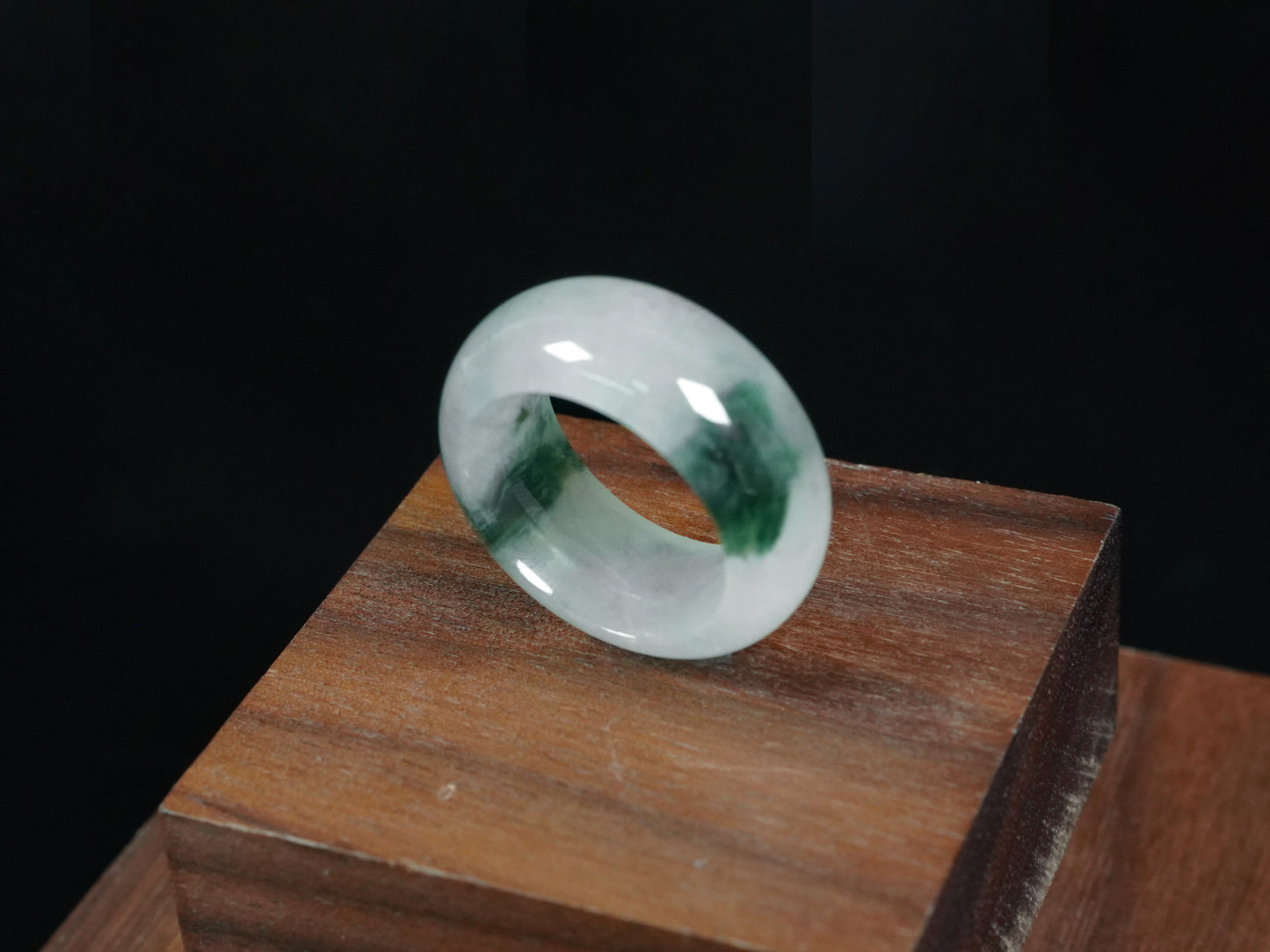 A white with dual deep green lines jadeite ring.