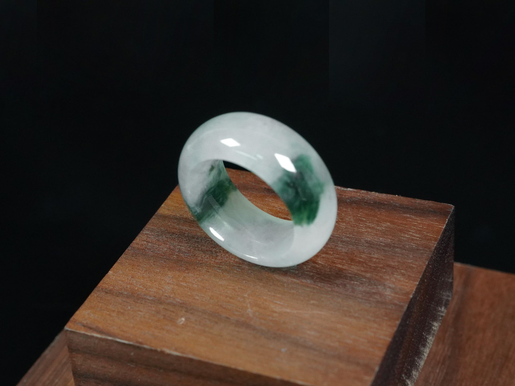 A white with dual deep green lines jadeite ring.