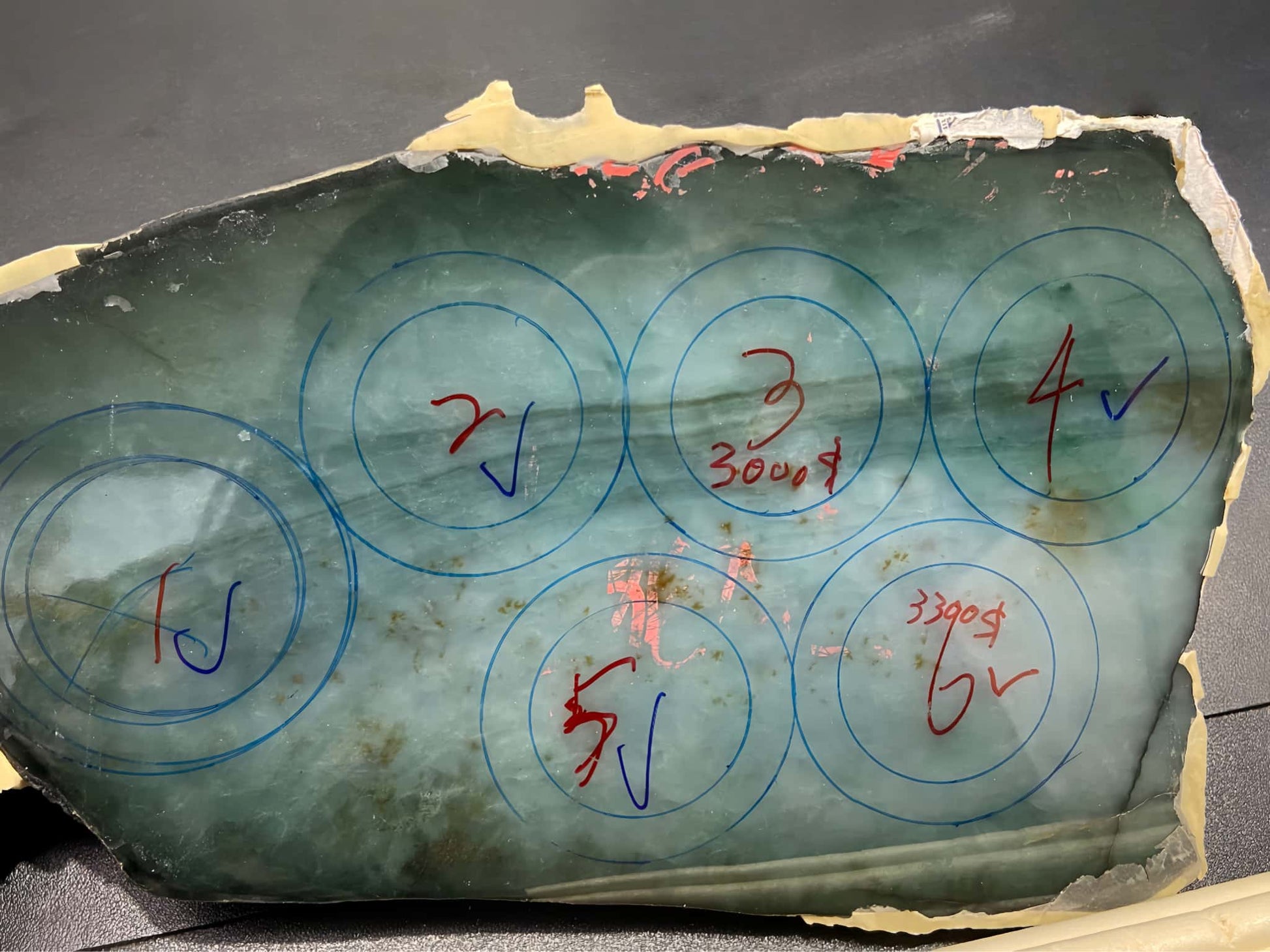 Geological sample with circular measurements and annotations on a black background. Multi-purpose Carving of Jadeite Rough Stones & Custom Bangle Services