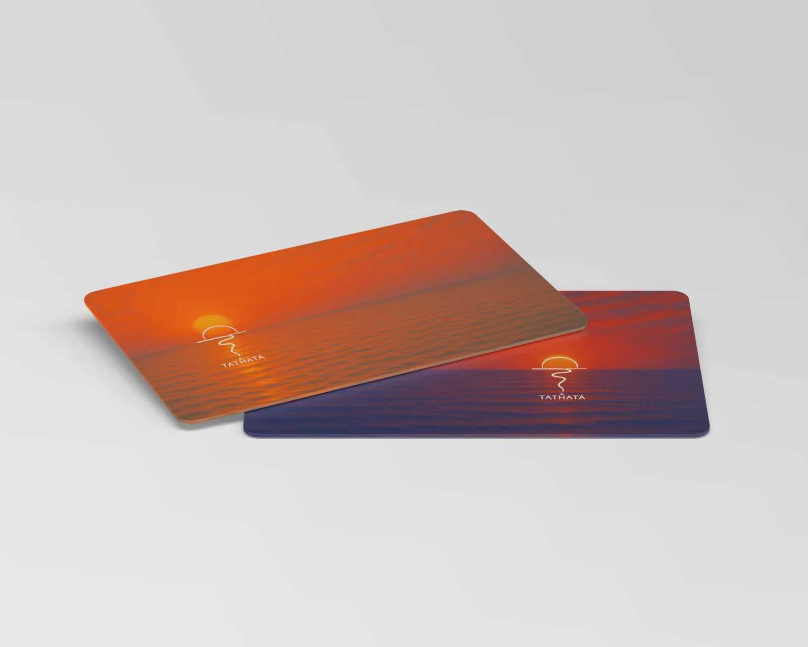 Two cards, one orange and one blue, with a logo tathata on a light gray background