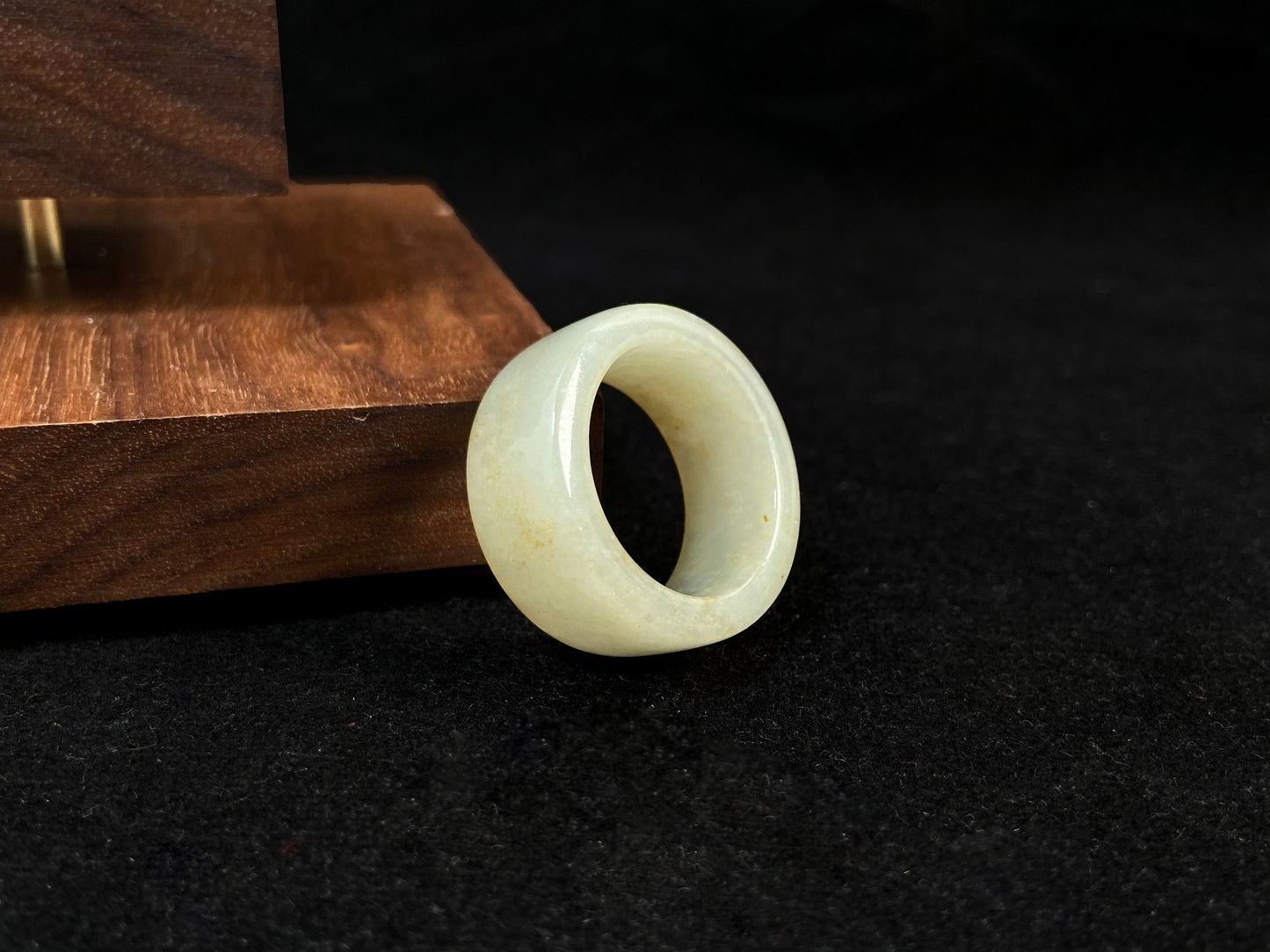 A creamy white jadeite thumb ring accented with golden specks.